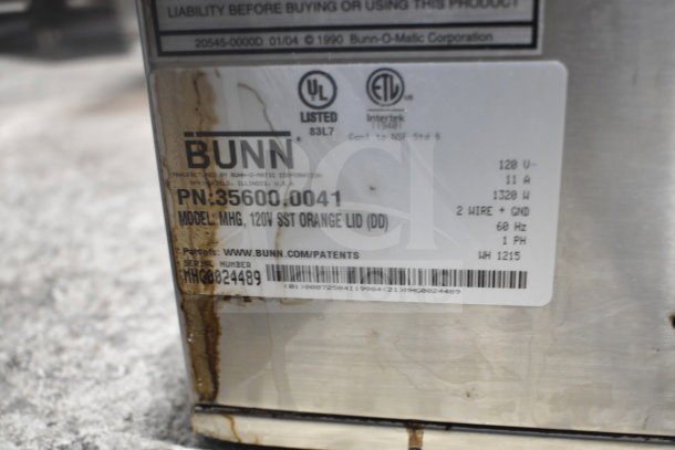 Bunn MHG Commercial Coffee Bean Grinder label, showing model, 120V, 11A, and other specifications. Visibly stained condition.