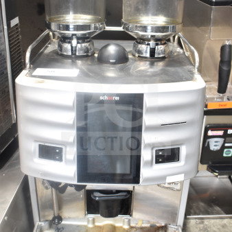 Schaerer Coffee Art Espresso Machine with dual bean hoppers, touchscreen display, and visible wear. Model designed for commercial use.