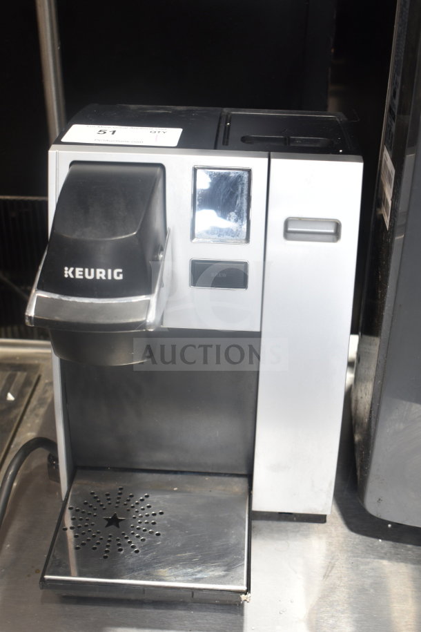 Keurig K150 countertop single cup coffee machine, 120 volts, 1 phase. Silver and black, good condition. Model visible.