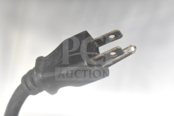 Alt text: Close-up of the power cord plug for a Keurig K150 coffee machine, showing two prongs and a grounded pin.