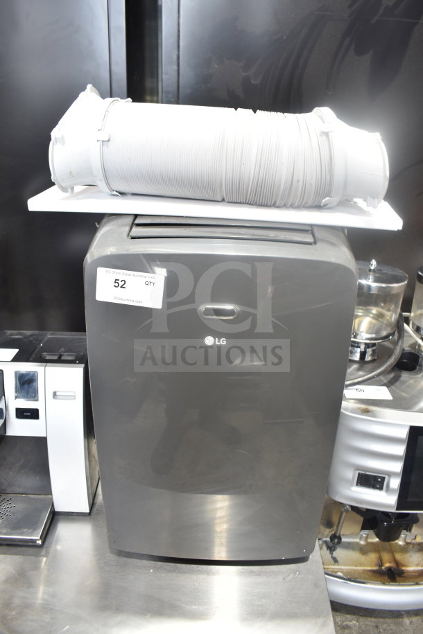 LG LP0823GSSM portable air conditioner, 115V, in good condition with exhaust hose on top. Auction label "52" visible.