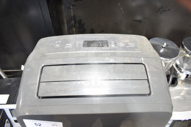 LG LP0823GSSM portable air conditioner, 115 volts, control panel view, slightly dusty, labels indicate settings.