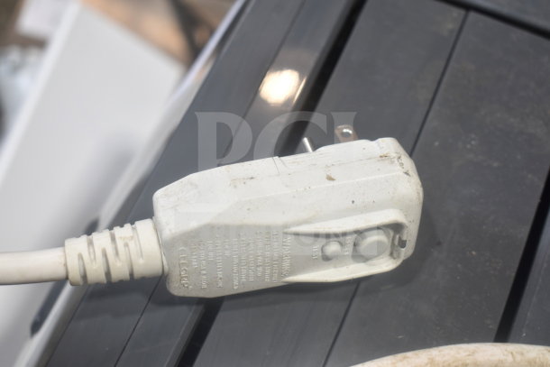 LG LP0823GSSM portable air conditioner plug showing 115V, 1-phase. The white plug has visible text and slight wear.