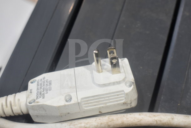 Close-up of a power plug for LG LP0823GSSM Portable Air Conditioner, 115 volts, visible dirt on cord.