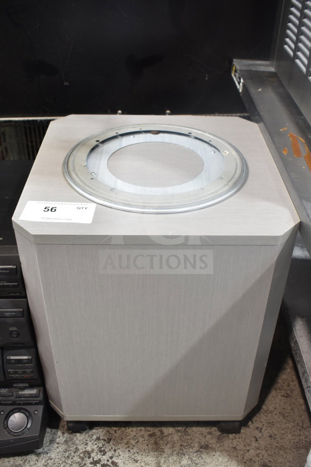 Speaker on casters, unfinished top, gray wood finish. Auction tag "56" visible on the corner. Good condition.