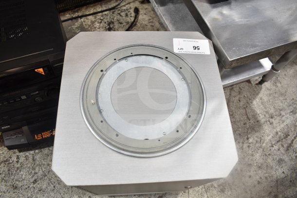 Speaker on casters with metal casing, featuring a circular grille on top. Visible auction tag with lot number 56.