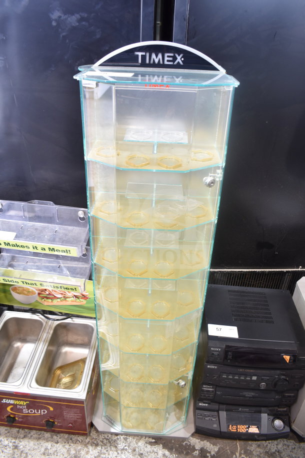 Timex display rack with glass shelves and hexagonal holders, featuring brand logo on top. Good condition.