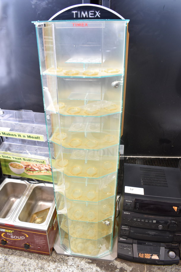 Timex display rack with transparent glass shelves, rotating design, lockable door, and branding on the top. Excellent condition.