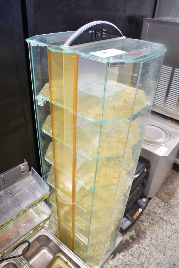 Glass display rack with multiple shelves, branded "Timex" on top. Features include clear panels and golden dividers. Good condition.
