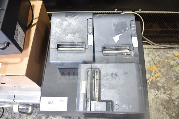 7 items including 4 cash drawers and 3 Epson receipt printers, showing signs of wear, stacked on auction display.