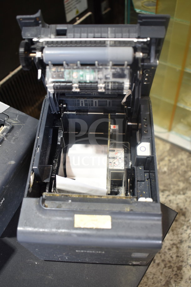 Epson receipt printer with open top showing internal components, fair condition; part of 7-item auction lot with cash drawers.
