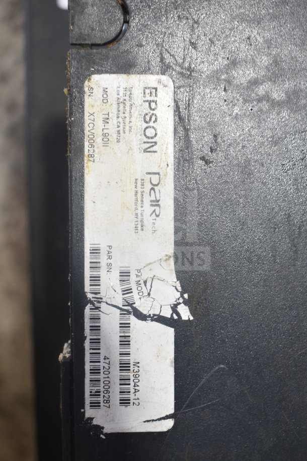 Epson receipt printer, model TM-L90II, visible serial number, partially worn label, scratches on surface.