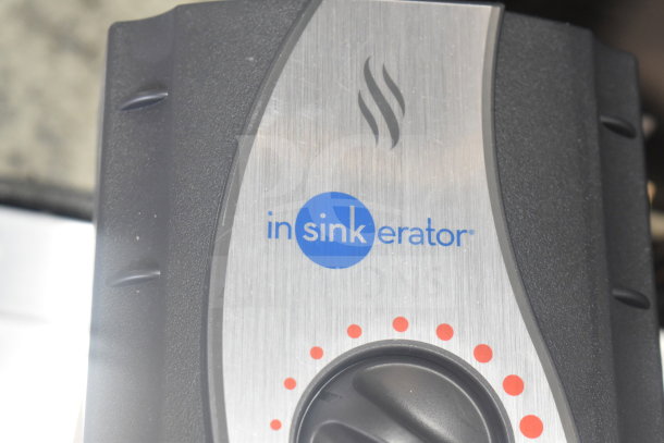 Insinkerator hot water heater, silver and black, logo displayed prominently on front panel.