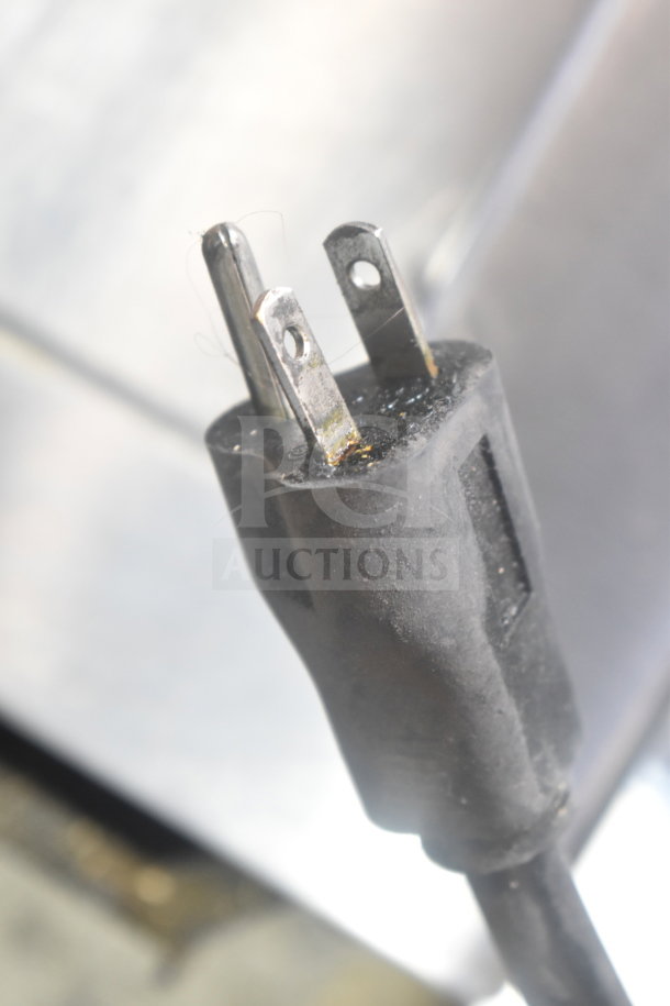 Plug of Solwave Commercial Countertop Microwave Oven, showing slight wear. Sturdy three-prong design for commercial use.
