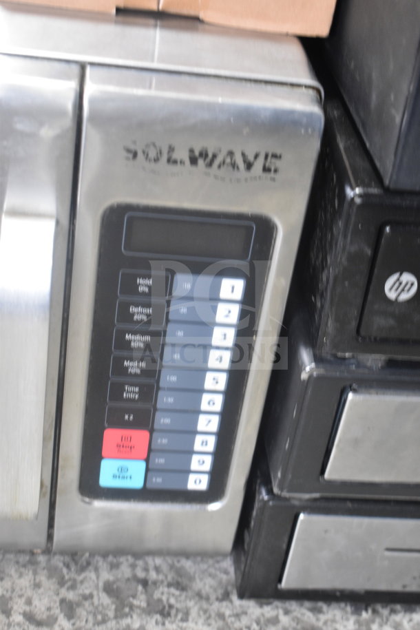 Solwave Commercial Countertop Microwave Oven with keypad. Brushed metal finish. Model details not visible. Used condition.