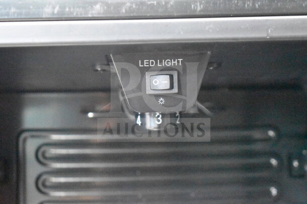 Arctic King ARV115B1AST mini cooler interior switch showing LED light control and temperature settings knob.