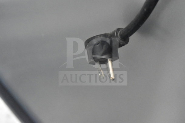 A 115V, 1-phase power plug of a 2022 True T-19F-HC freezer on commercial casters.