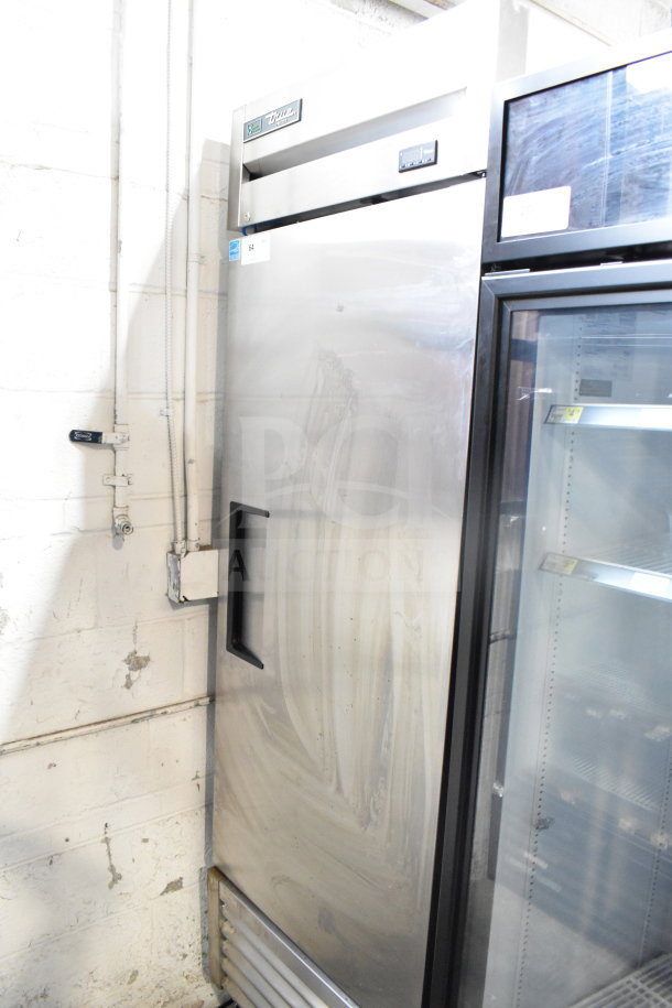 True Commercial Single Door Reach In Freezer, stainless steel, 115 volts, 1 phase; shows signs of wear; True brand visible.