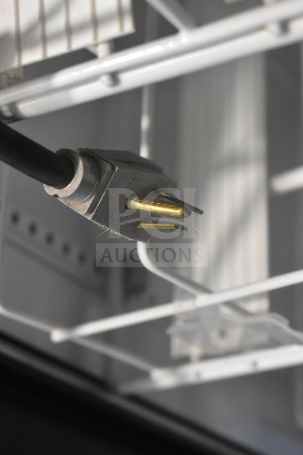 Close-up of a power plug inside a True GDM-41SL-48-HC-LD commercial cooler, showing clean wiring and shelving.