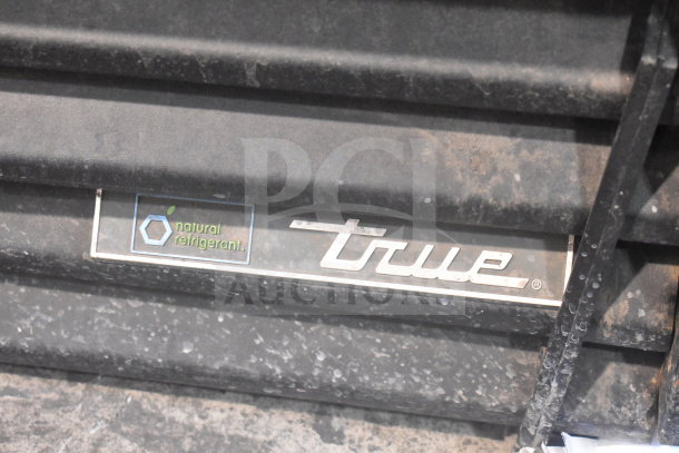 2016 True GDM-41SL-48-HC-LD cooler panel with "natural refrigerant" label, showing slight wear.