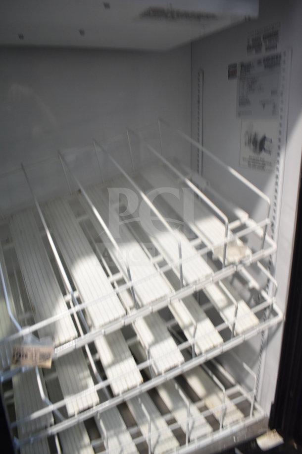 2016 True GDM-41SL-48-HC-LD Commercial Cooler with shelving, 115V, clean interior, visible model label, 2-door design.