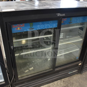 2019 True GDM-41SL-48-HC-LD 2 Door Reach In Cooler Merchandiser with Red Bull and Monster branding, in good condition.