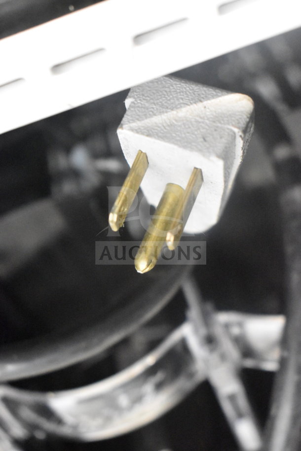 Close-up of a three-prong plug from the 2019 True GDM-41SL-48-HC-LD cooler, highlighting electrical compatibility.