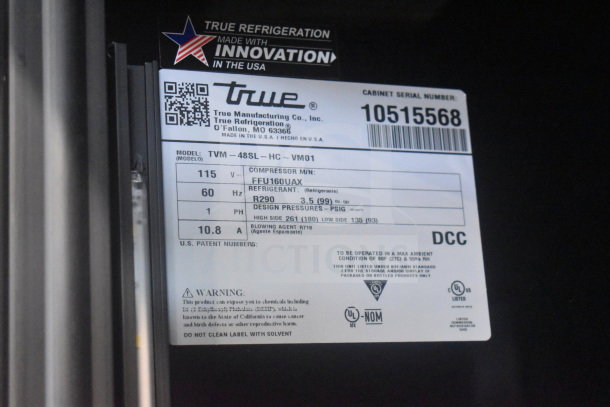 Label of 2022 True TVM-48SL-HC Cooler Merchandiser shows model, serial number, 115 volts, 1 phase, refrigerant R290.