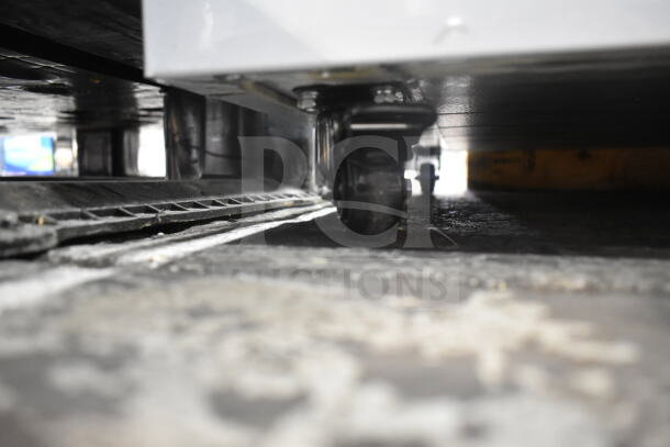 KoolMore KM-ISCF-78MD chest freezer on casters, close-up of commercial wheels, brand new with minor scratches.