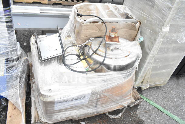 Pallet lot with mixed items including cutting boards, metal container, and cables. Wrapped in plastic. Condition varies.