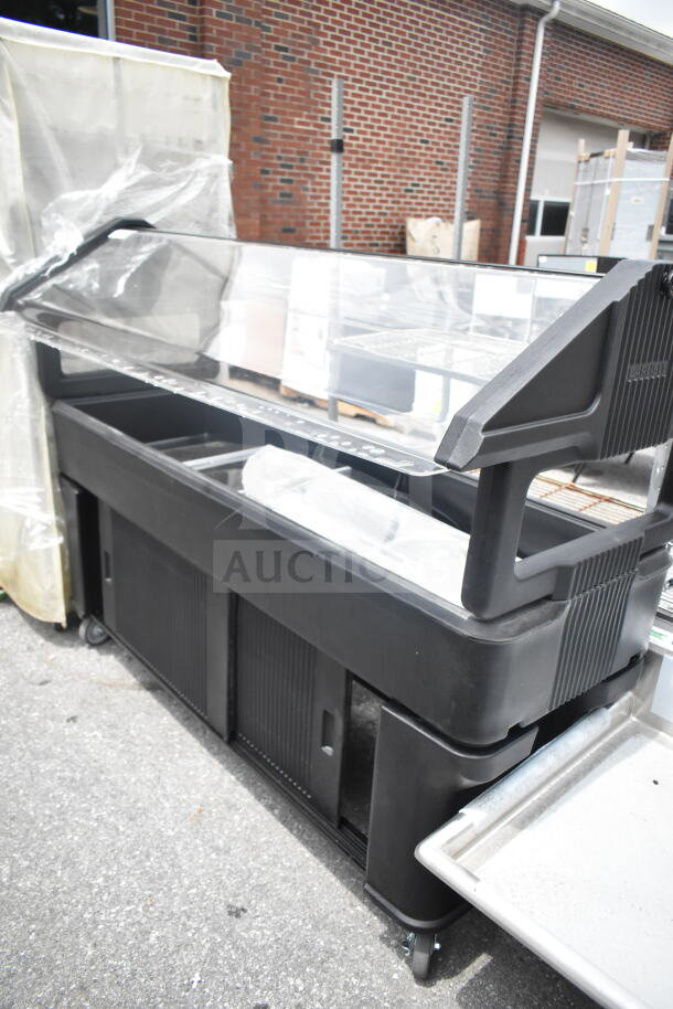 Cambro Black Poly Salad Bar with wheels, clear sneeze guard, and multiple compartments. Good condition, ideal for buffet use.