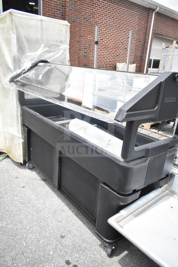 Cambro black poly salad bar with protective cover, wheeled base, and transparent sneeze guard, in good condition.