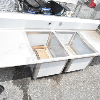 "Brand new Regency 600S21824224 commercial 2-bay sink, dual drain boards, minor scratches, stainless steel, ideal for kitchens."