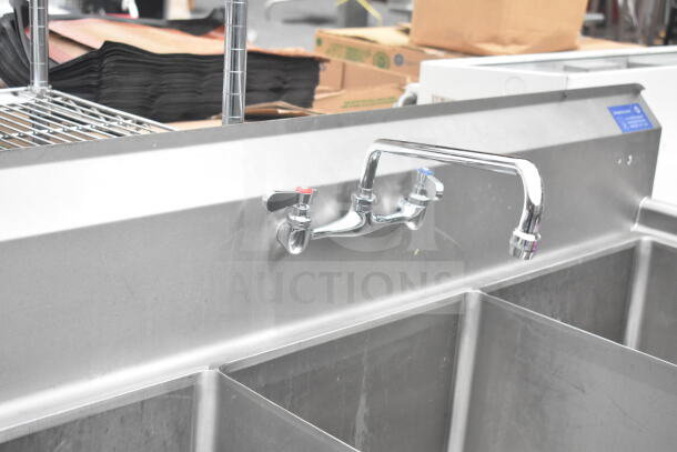 Commercial 3 bay sink with faucet and handles, stainless steel, slightly used condition, ideal for restaurant use.