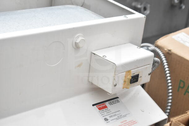 Dayton 6E825B Air Curtain Cabinet in clean condition, with visible labels and controls for fan operation.