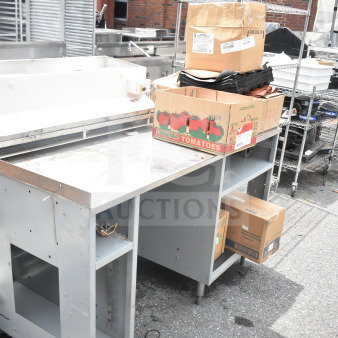 Duke Subway sandwich make line piece with boxes on top, including baking pan liners, shown outdoors.