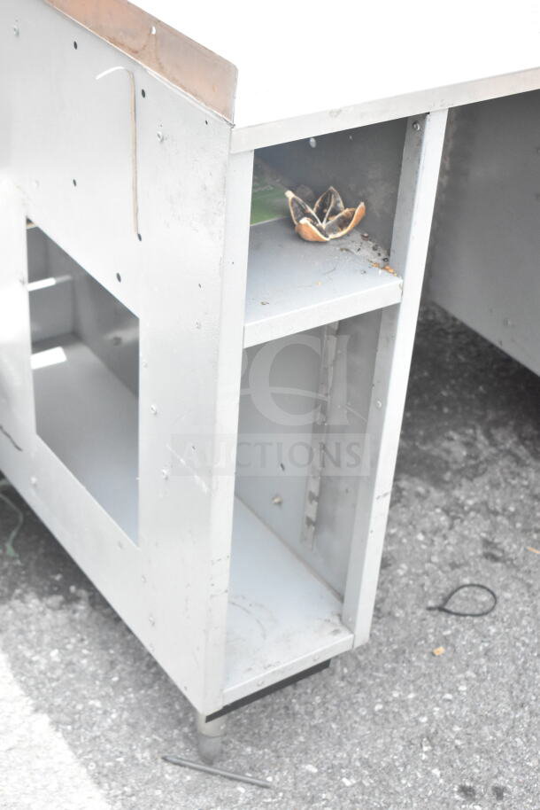 Duke Subway sandwich make line piece with visible shelf, showing wear. Includes baking pan liners. Metal frame, used condition.