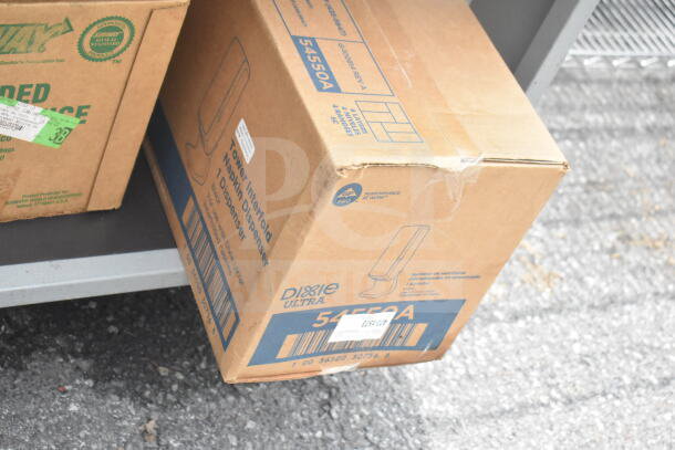 Boxes for Dixie Ultra napkin dispenser and Subway items on Duke sandwich make line, includes baking pan liners.