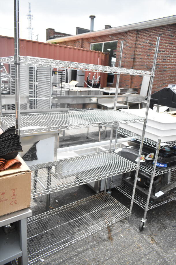 Chrome finish 4-tier wire shelving unit with wheels, excellent condition, buyer must dismantle.