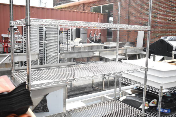 4-tier chrome finish wire shelving unit in fair condition, dismantling required by buyer, consider freight charges.
