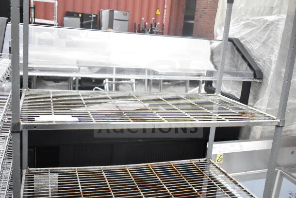 Gray finish 3-tier wire shelving unit in used condition, requiring buyer dismantling for shipping.