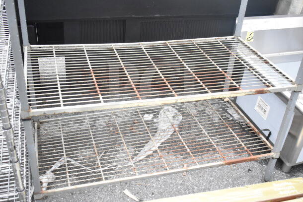 Gray finish 3-tier wire shelving unit, shows rust and wear, buyer must dismantle, consider freight charges.