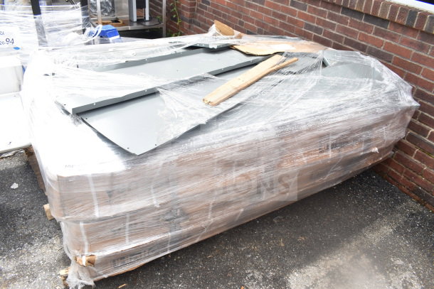 Pallet lot of brand new gray metal lockers, wrapped in plastic. Some visible scratches and dents.