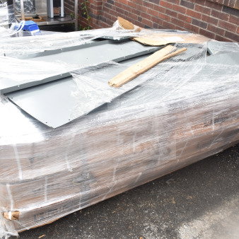 Pallet lot of brand new gray metal lockers, wrapped in plastic. Some visible scratches and dents.