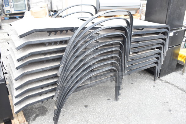9 stacked outdoor chaise lounge chairs with black metal frames, textured gray seating. Good used condition.