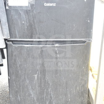 Galanz GL31BKE mini cooler with freezer, visible scratches, black finish, 120 volts, 1 phase, auction label attached.