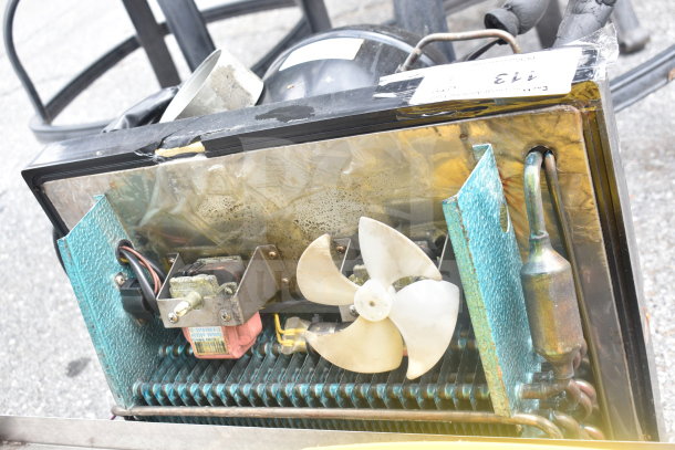 Embraco FFI 12HBX Compressor, 220 Volts, includes visible wiring and fan, used condition, auction number tag attached.