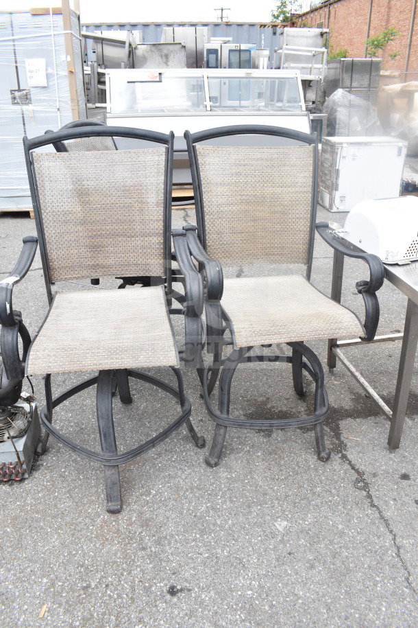 Three outdoor armchairs with metal frames and mesh seats. Slightly weathered condition. Ideal for patio use.