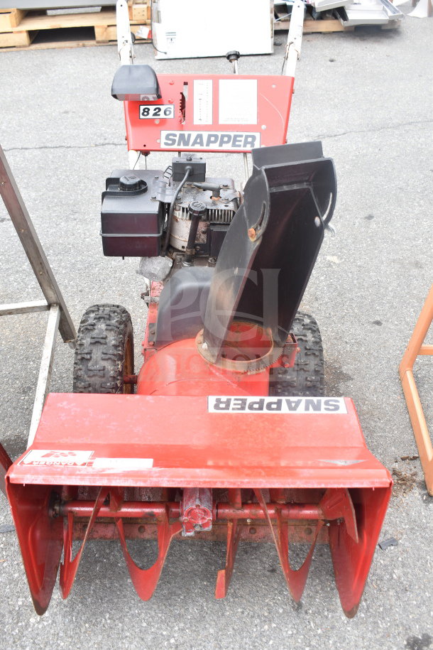 Snapper 8262 Snow Thrower, visible Snapper branding, red chassis, dual wheels, moderate wear, gas-powered engine.