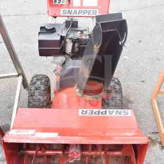 Snapper 8262 Snow Thrower, visible Snapper branding, red chassis, dual wheels, moderate wear, gas-powered engine.